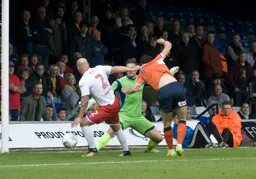 Despite David Pipe grabbing his shirt, Danny Hylton scores Town`s second goal