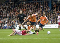 Harry Cornick hurdles over a fallen Ronnie Henry