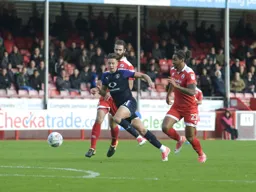 Harry Cornick bursts through between defenders