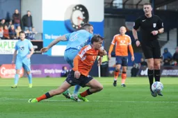 Luke Berry is sent tumbling by Liam Kelly