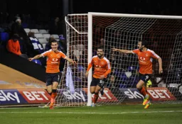 Dan Potts, Elliot Lee and Danny Hylton celebrate the second goal