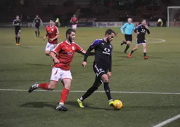 Andrew Shinnie shields the ball