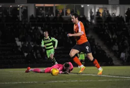 Danny Hylton pounces on Brad Collins mistake to make the score 2-0