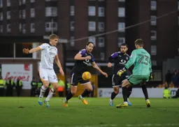 Danny Hylton bursts through but Ryan Boot stands in his way