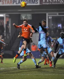 Luke Berry climbs to meet the ball
