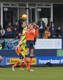 Luke Berry and former Hatter Jayden Stockley compete for a high ball