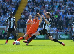 Danny Hylton and Sean Brisley go for the ball fully committed