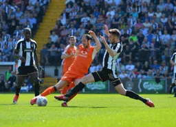 Danny Hylton and Sean Brisley go for the ball fully committed