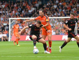 Danny Hylton tries to win the ball back