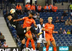 Isaac Vassell challenges the keeper