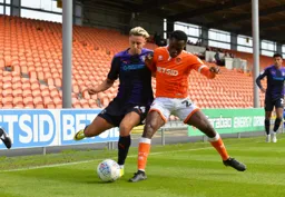 Harry Cornick holds off his man