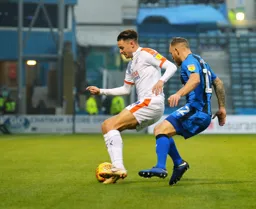 Harry Cornick shields the ball
