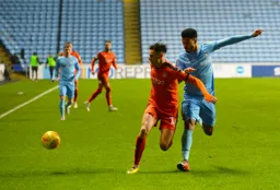 Harry Cornick shields the ball