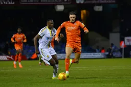 Harry Cornick beats his man to the ball