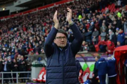 Mick Harford applauds the fans