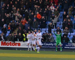 Matty Pearson celebrates his goal in front of the Luton fans