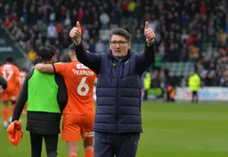 Mick Harford gives a double thumbs up to the fans