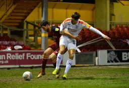 Harry Cornick challenges for the ball