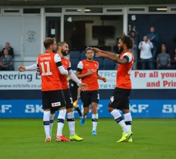 Izzy Brown and Andrew Shinnie celebrate with Elliot Lee after scoring from the penalty spot