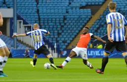 Kazenga LuaLua going in for a 50 50 with Barry Bannan