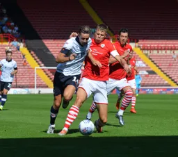 Harry Cornick skips away from future Hatter Mads Andersen