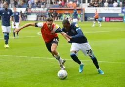 Harry Cornick trying to win the ball back against Jaden Brown