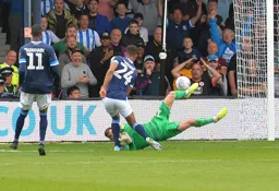 Simon Sluga gets down to Steve Mounie's feet to prevent a late equaliser