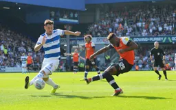 Kazenga LuaLua sends in a cross, Grant Hall is trying to block it