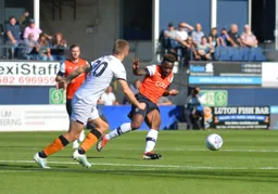 Kazenga LuaLua keeps the ball away from Jarrod Bowen
