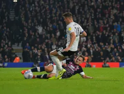 Luke Bolton putting in a full blooded tackle to win the ball off Tom Cairney