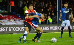 James Collins trying to win the ball back from Matty Cash