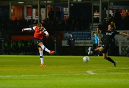Andrew Shinnie lets fly from outside the box and Connor Gallagher tries to block the shot