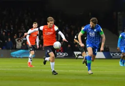 Luke Berry strides through midfield with Charlie Mulgrew in his wake