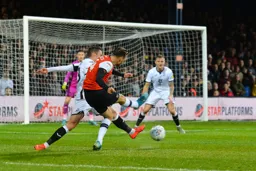 Harry Cornick tries to bend one in the far corner