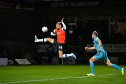 Harry Cornick latches onto a ball over the top, leaving Matt Clark chasing