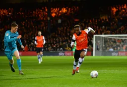 Kazenga LuaLua powers down the flank, tormenting Jason Knight with his pace