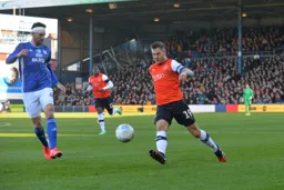 James Collins trying to bring the ball under control and cut inside, being watched by Sean Morrison