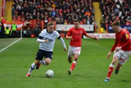 Luke Bolton cutting in off the right flank, trying to get the best of Josh Cullen and Alfie Doughty