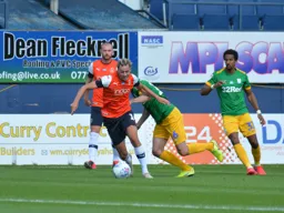 A Cornrowed Harry Cornick gets away from Andrew Hughes and drives into the box
