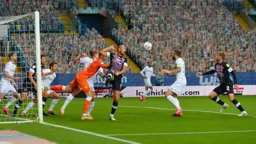 Goalmouth scramble and Martin Cranie waits for the ball to drop