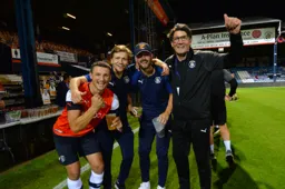 Matty Pearson, Luke Berry, Danny Hylton and Mick Harford celebrate the Towns' survival in the Championship