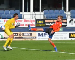 Luke Berry toe ends the ball past David Marshall for the Town`s first goal