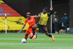 Kazenga LuaLua tussles for the ball with Tom Dele-Bashiru