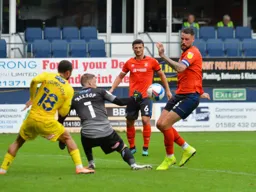 Ryan Allsop scrambles the ball away from Sonny Bradley