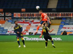 Rhys Norrington-Davies sends a header down field