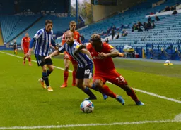 Kazenga LuaLua tries to get past Barry Bannon