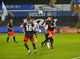 Glen Rea looks to find Jordan Clark with a headed clearance