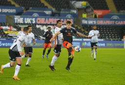 James Collins controls the ball under pressure from Kyle Naughton