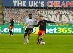 Luke Berry plays the ball with the outside of his foot