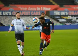 Kazenga LuaLua heads the ball forward